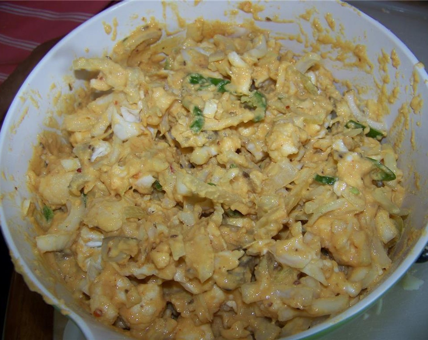 step 9 Mix potato, cauliflower, onion, green cabbage, and green chili pepper in a large bowl.