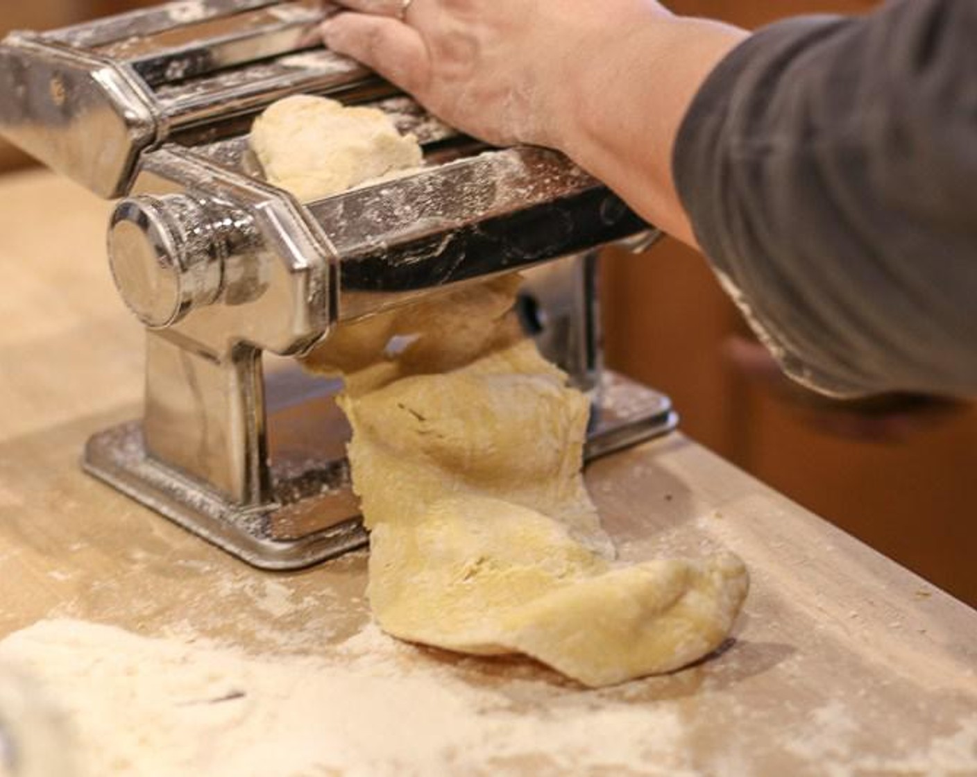 step 5 Run the dough through a floured pasta machine, with the flat rollers set to the most open setting. Roll it back through the pasta maker again. If the dough sticks, coat with a little more flour. Fold and roll the dough three more times, adjusting the machine to make the pasta thin.