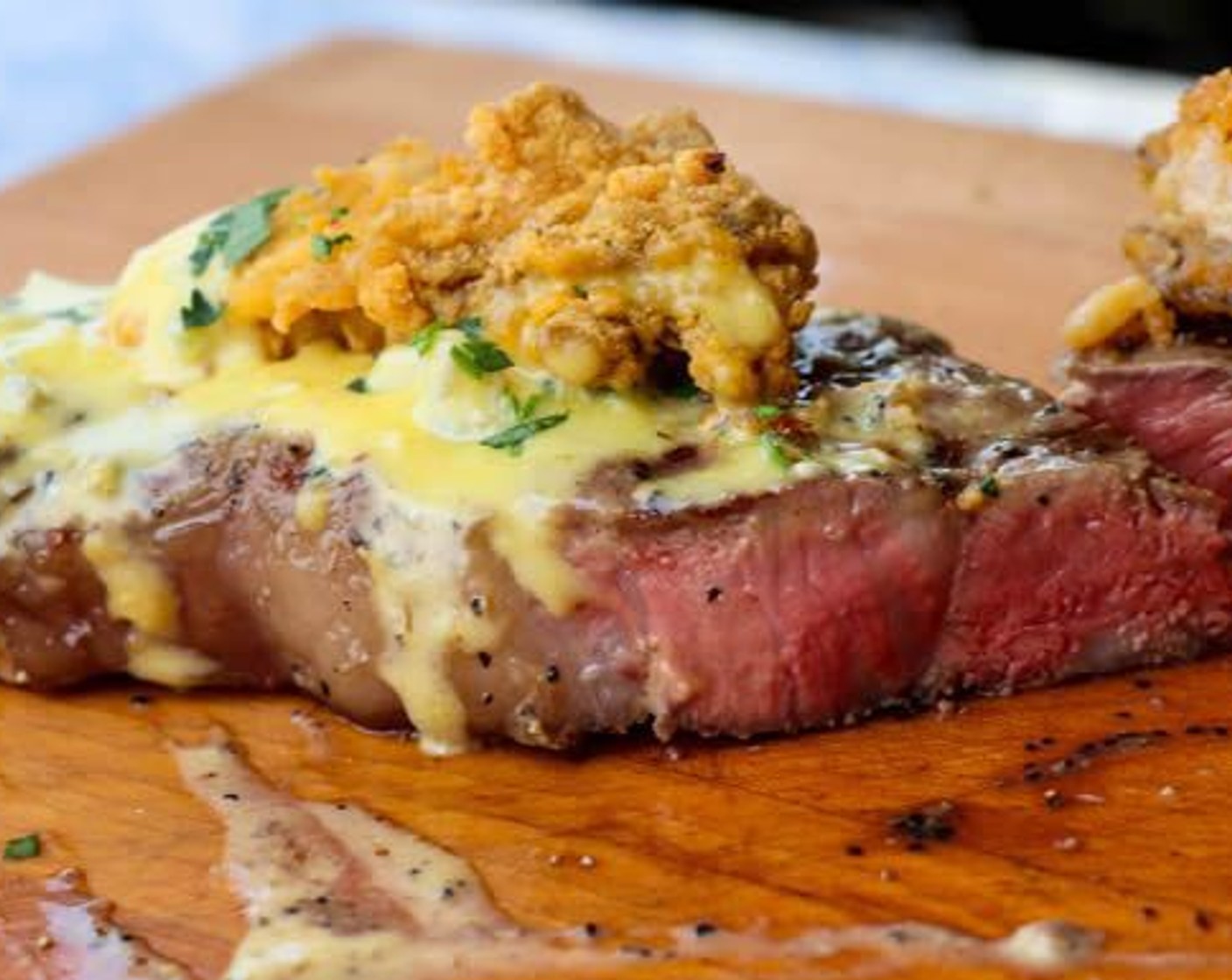 step 11 Place Strip Steaks on serving platter and top with fried oysters. Drizzle blue cheese hollandaise over the top and garnish with Fresh Parsley (to taste).