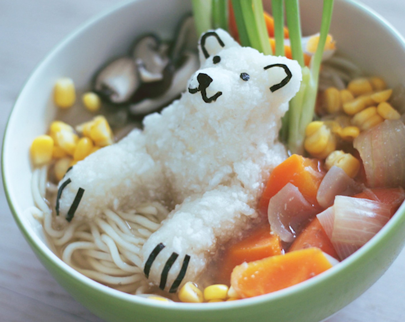 step 11 Place the polar bear in the bowl, then arrange veggies, Corn (1/2 cup), Scallion (1 bunch), and add more broth. Serve and enjoy!