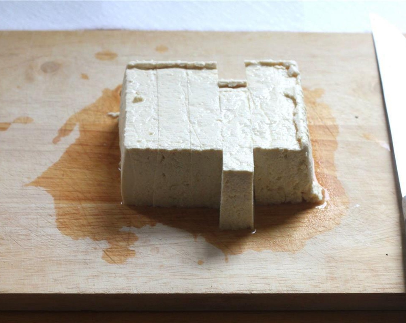 step 1 Start by slicing the Extra Firm Tofu (1 pckg) into six slabs, and pressing gently between a few sheets of paper towels. Let them sit between the paper towel for about 10 minutes to drain excess water.