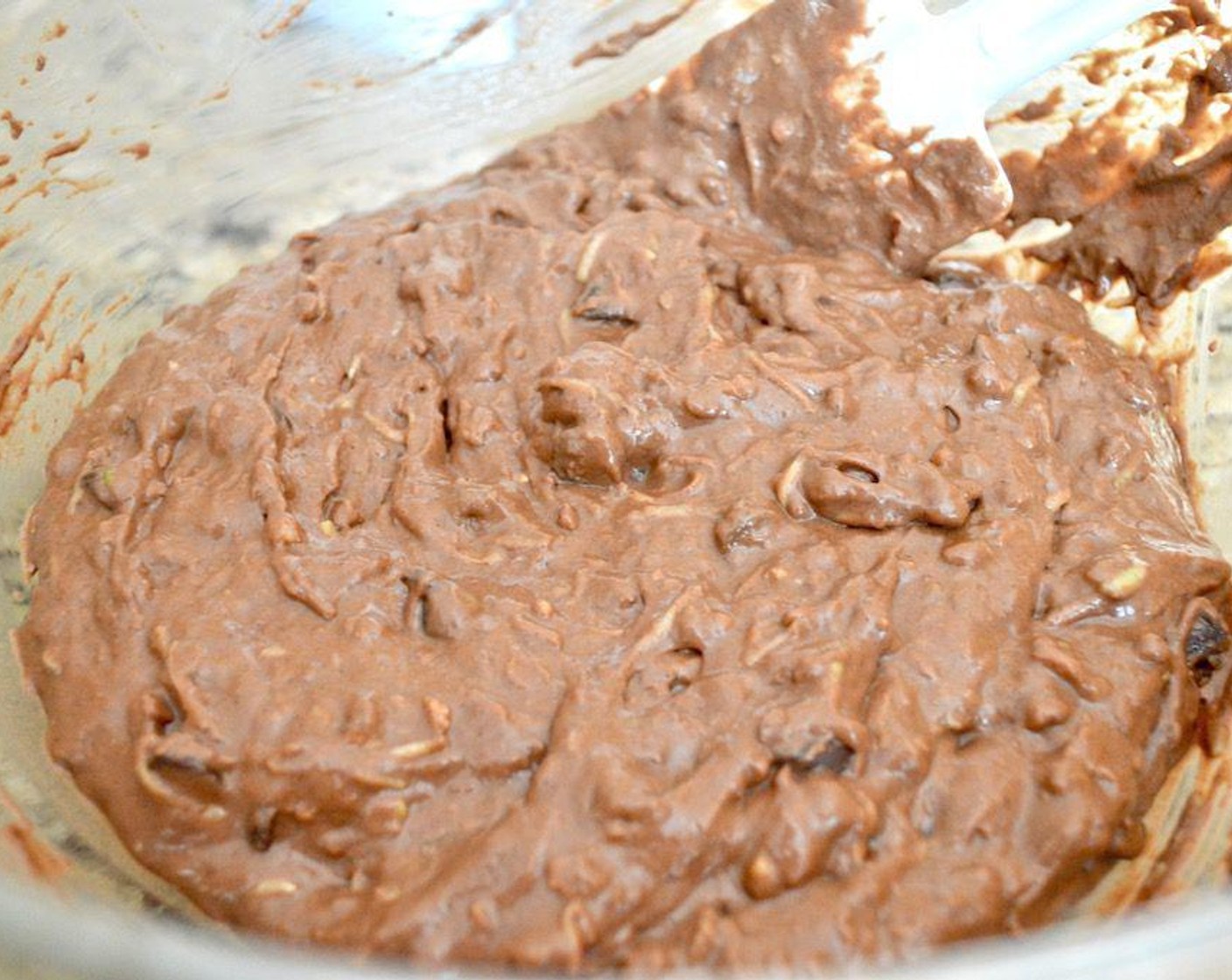 step 3 Then whisk the cooled Coconut Oil (2 Tbsp), Egg (1), Vanilla Extract (1/2 tsp), Chocolate Almond Milk (1/2 cup), Honey (1/3 cup), and Cinnamon Apple Sauce (1/4 cup) together thoroughly in another bowl. Pour those wet ingredients into the dry ingredients and whisk it all together into a thick batter.