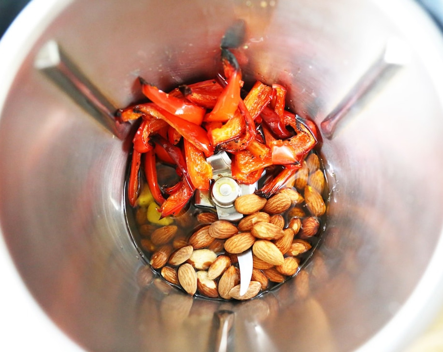 step 7 Make the red pepper sauce by placing red peppers, Garlic (1 clove), Almonds (1 cup), Lemon (1), in the Thermomix jug and blend for 45 seconds on speed 5.