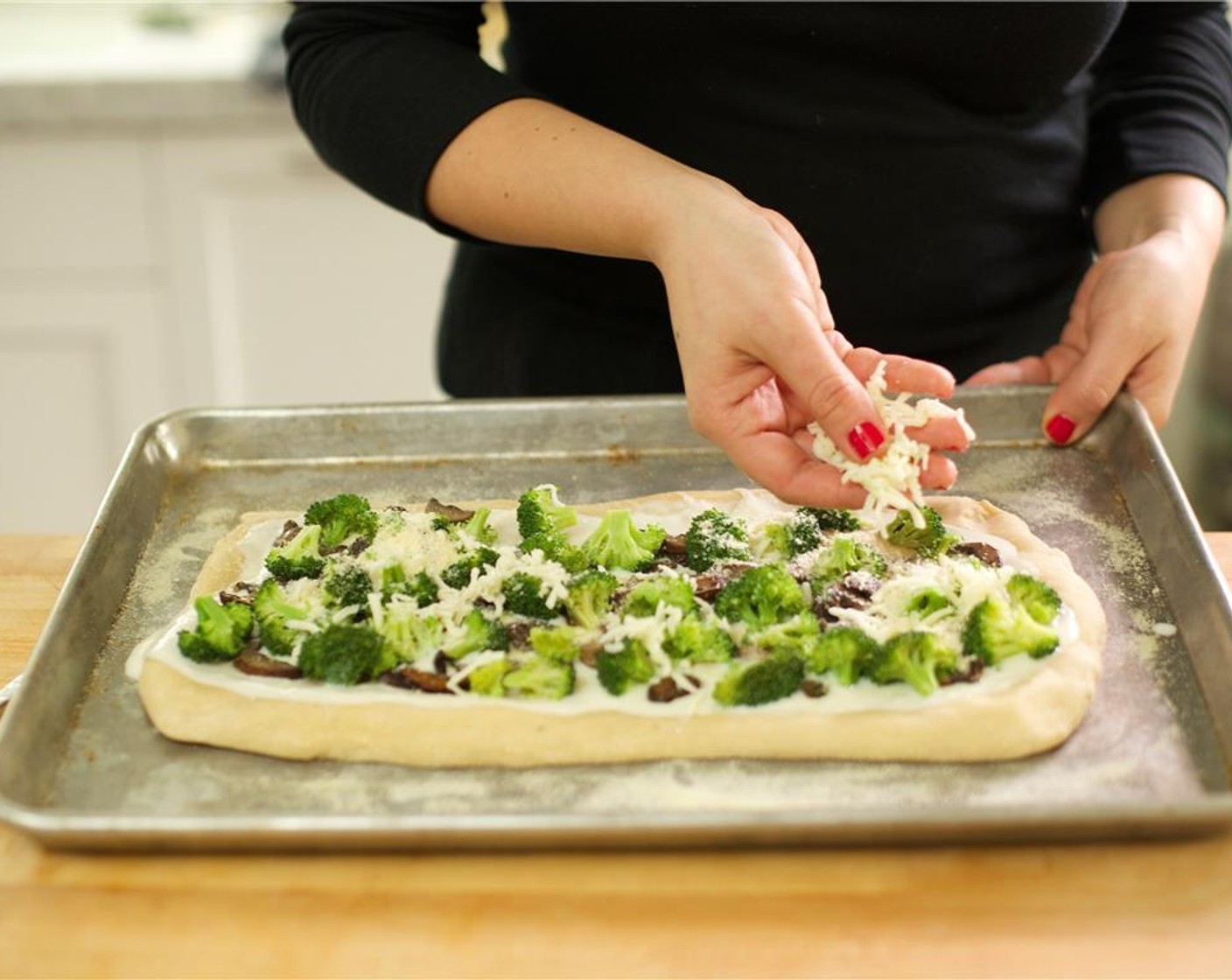step 12 Remove from the oven and spread more sauce evenly oven the dough. Use a slotted spoon to place broccoli onto the crust and then add the mushrooms, evenly spreading the ingredients. Sprinkle remaining Mozzarella Cheese (1/4 cup) and grated Parmesan Cheese (2 Tbsp) on top.