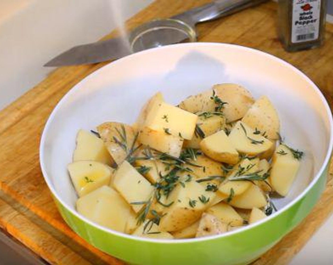step 3 Cut the Potatoes (4) into pieces, the smaller the crispier. In a bowl, add the potatoes, the Fresh Rosemary (1 sprig) the Fresh Thyme Leaves (2 sprigs), and the Olive Oil (2 Tbsp). Season with Salt (to taste) and Ground Black Pepper (to taste). Mix thoroughly.