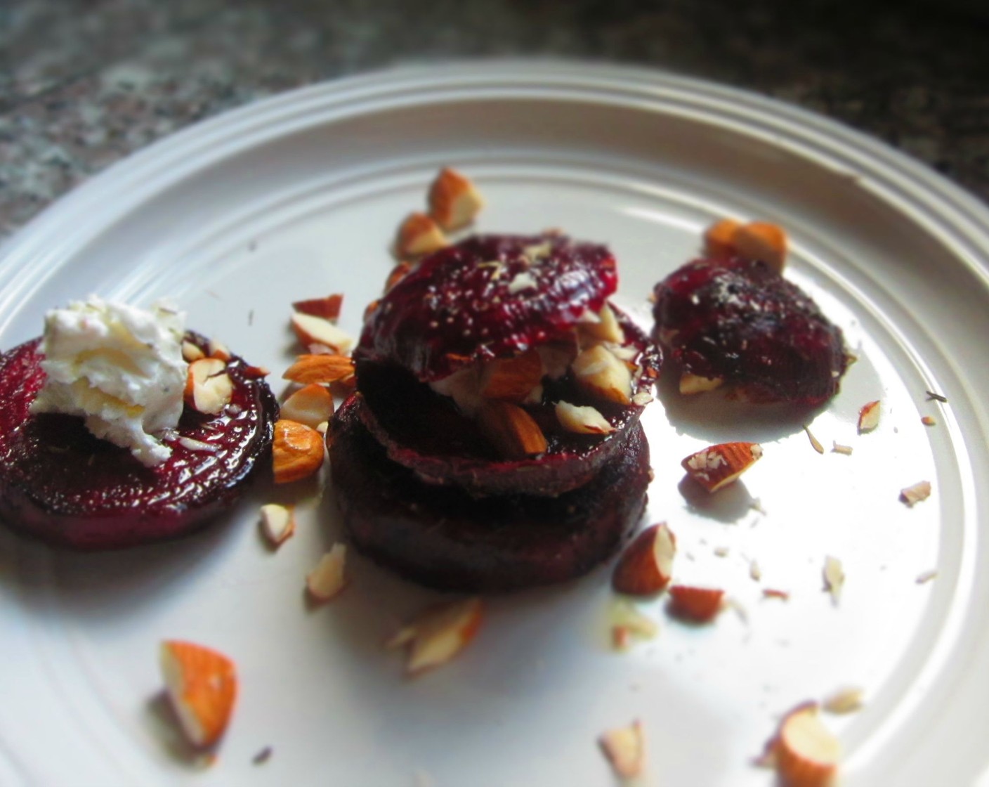 step 9 To finish, drizzle remaining Olive Oil (2 Tbsp) on top of beet stacks and sprinkle some chopped almonds on top for presentation.