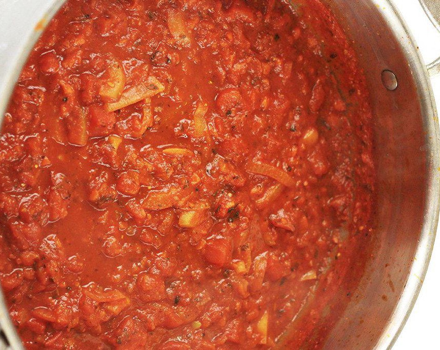 step 4 Add in Canned Fire Roasted Diced Tomatoes (3 1/2 cups), Tomato Sauce (1 3/4 cups), Sea Salt (1/2 tsp), Dried Oregano (1 tsp), Dried Thyme (1 tsp), Dried Basil (1 tsp), Smoked Paprika (1 tsp), Ground Turmeric (1 tsp), and Brown Sugar (2 Tbsp). Reduce heat to a simmer and allow to cook 10 minutes more, stirring occasionally. Taste and add salt to taste.