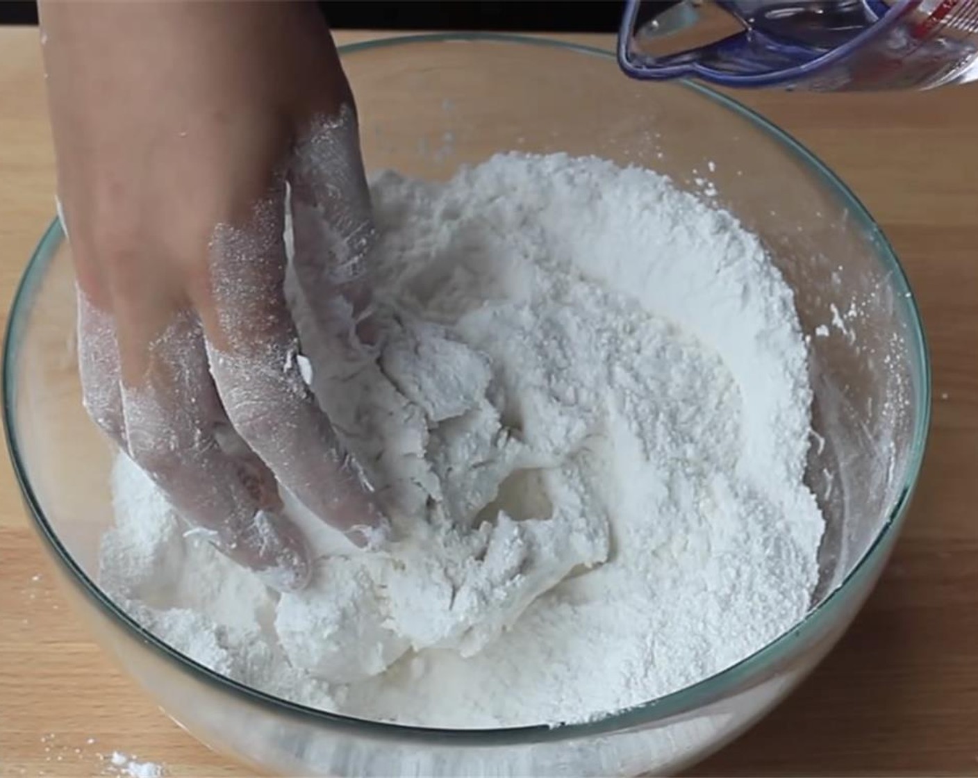 step 3 In a large bowl, mix the remaining glutinous rice flour with Granulated Sugar (1/3 cup) and Baking Powder (1/2 tsp). Add in the small dough. Slowly stir in Water (to taste) and continue kneading until smooth.