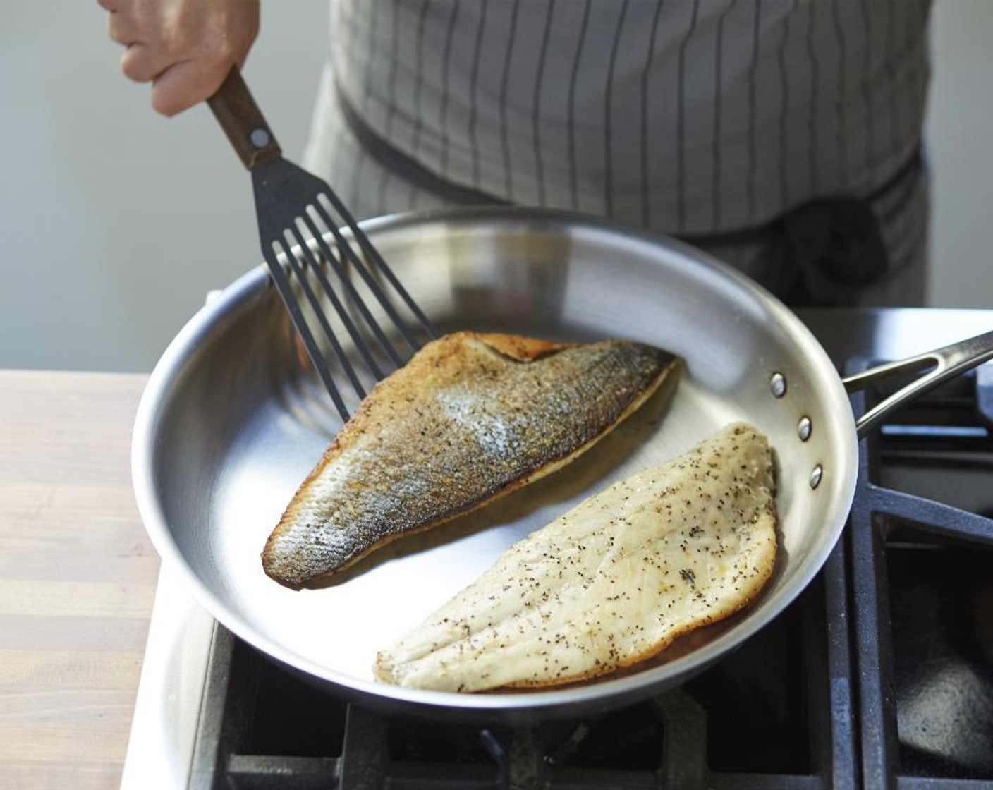 step 4 Heat the Olive Oil (1 Tbsp) in a medium sauté pan over medium- high heat and when hot add the fish skin side down and sear for 3 minutes.
