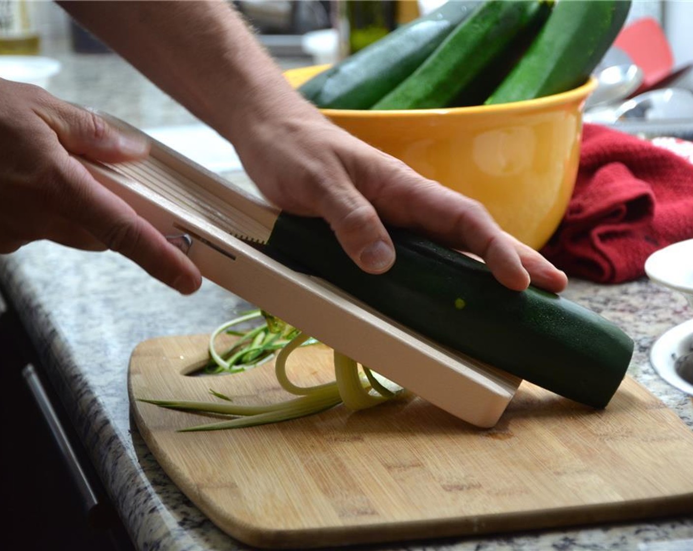 step 1 Using a mandolin with the julienne attachment, slice the Zucchini (2) on all four sides into spaghetti-like strands. Stop before you reach the seeds.