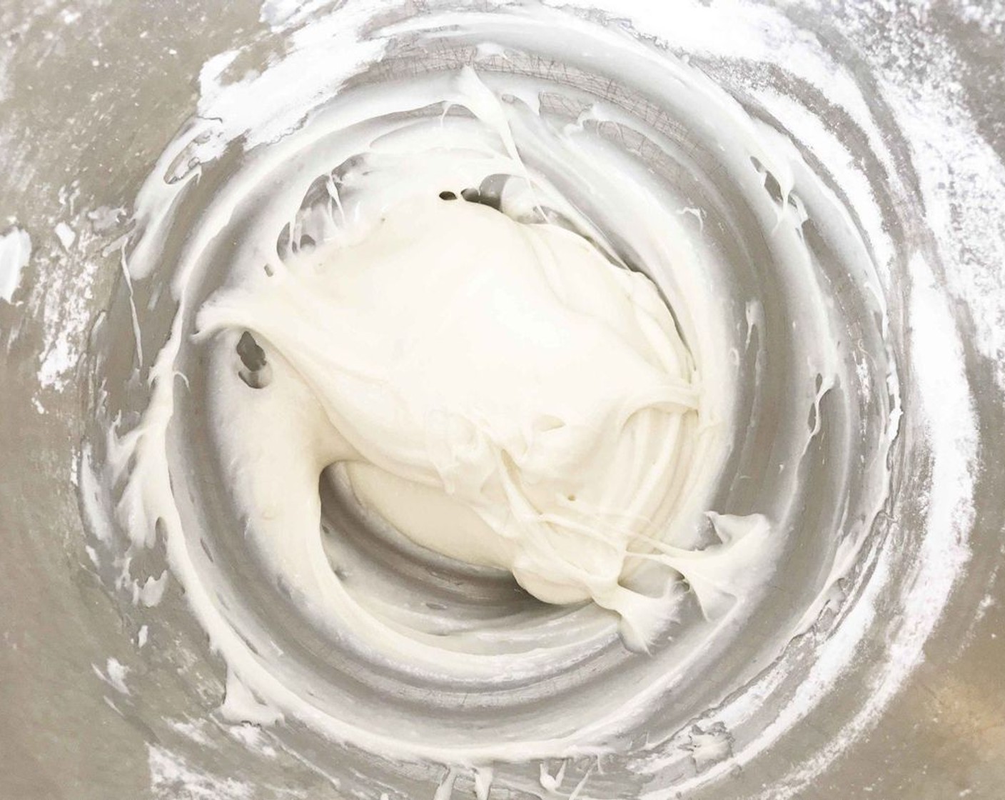 step 7 While the cakes are cooling, beat together the Neufchâtel Cheese (1 cup), Powdered Confectioners Sugar (1 1/2 cups), and Vanilla Extract (1 tsp) to create your cream cheese frosting.