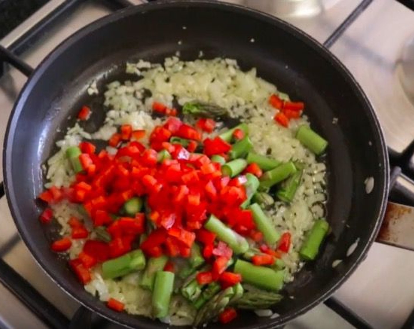 step 7 Add the asparagus and red bell peppers. Cook for about 4 minutes.