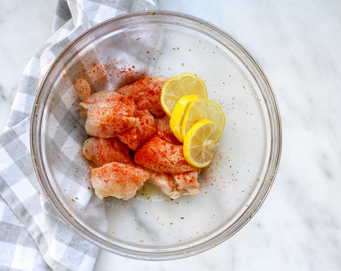 step 4 In a separate bowl, toss Chicken Breast (1 lb) with Lemon (1), Olive Oil (1 Tbsp), Dried Oregano (1 tsp), Simply Organic Garlic Powder (1/2 tsp), Smoked Paprika (1/4 tsp), Salt (to taste) and Ground Black Pepper (to taste).