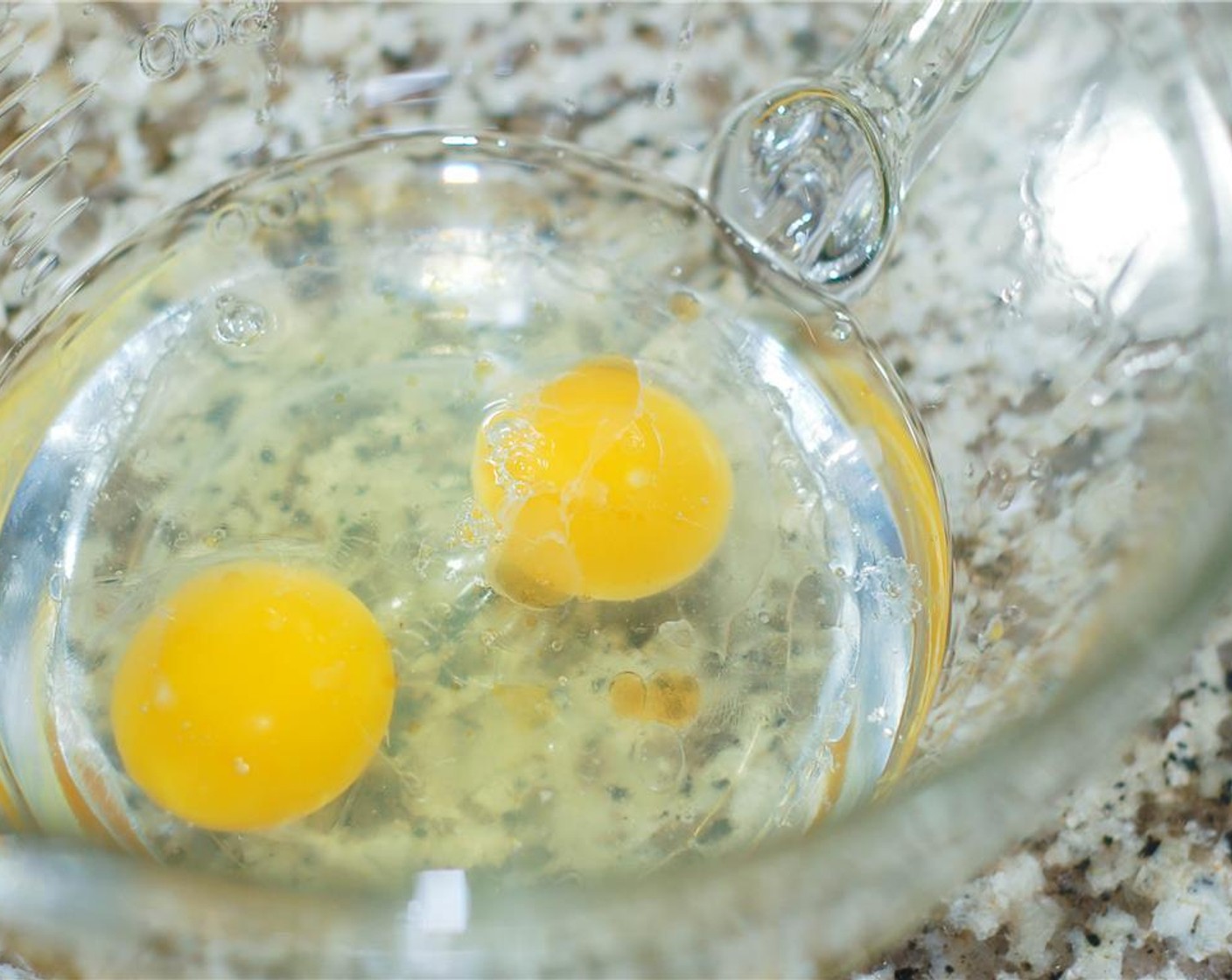 step 4 In a large bowl (preferably one that has a spout), whisk together the oils, Eggs (2), and LorAnn Oils® Butter Rum Flavor (2 drops) with a hand mixer.