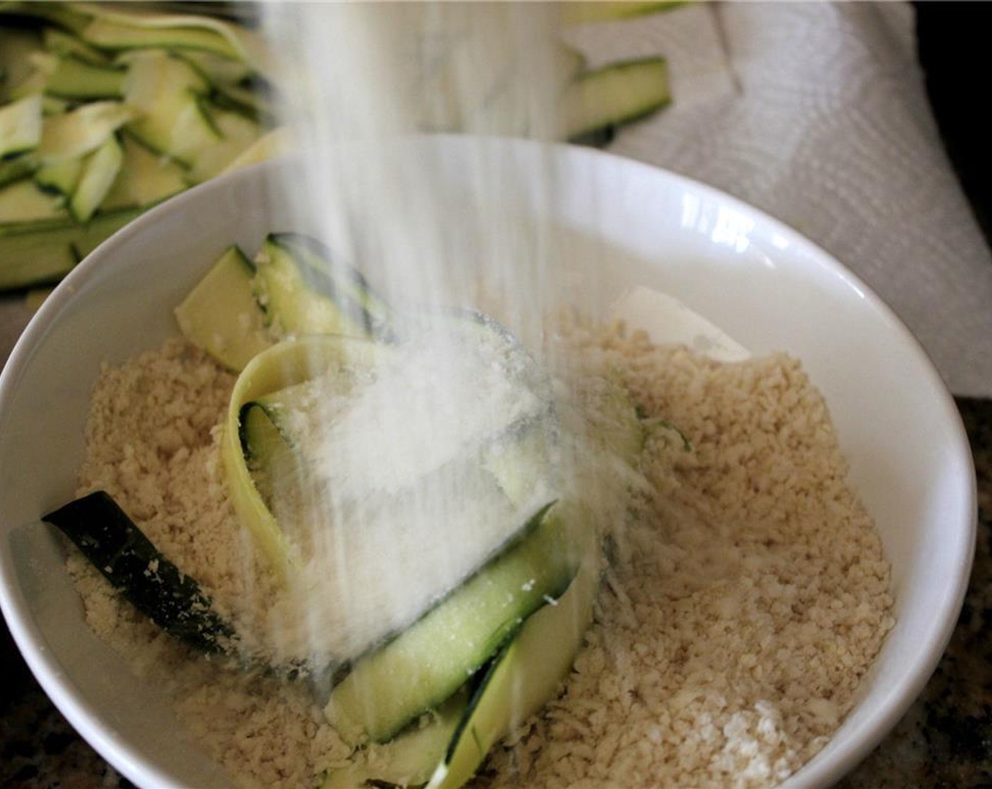 step 4 Combine the Panko Breadcrumbs (1/2 cup), Seasoned Breadcrumbs (1/2 cup), and Grated Parmesan Cheese (4 Tbsp) in a dish. Take the wet zucchini and coat with the crumb mixture.