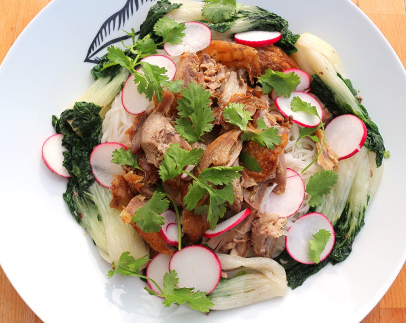 step 11 Place the noodles in a large serving bowl, top with Radish (1 bunch), shredded duck meat, and Fresh Cilantro (to taste) add the duck stock.