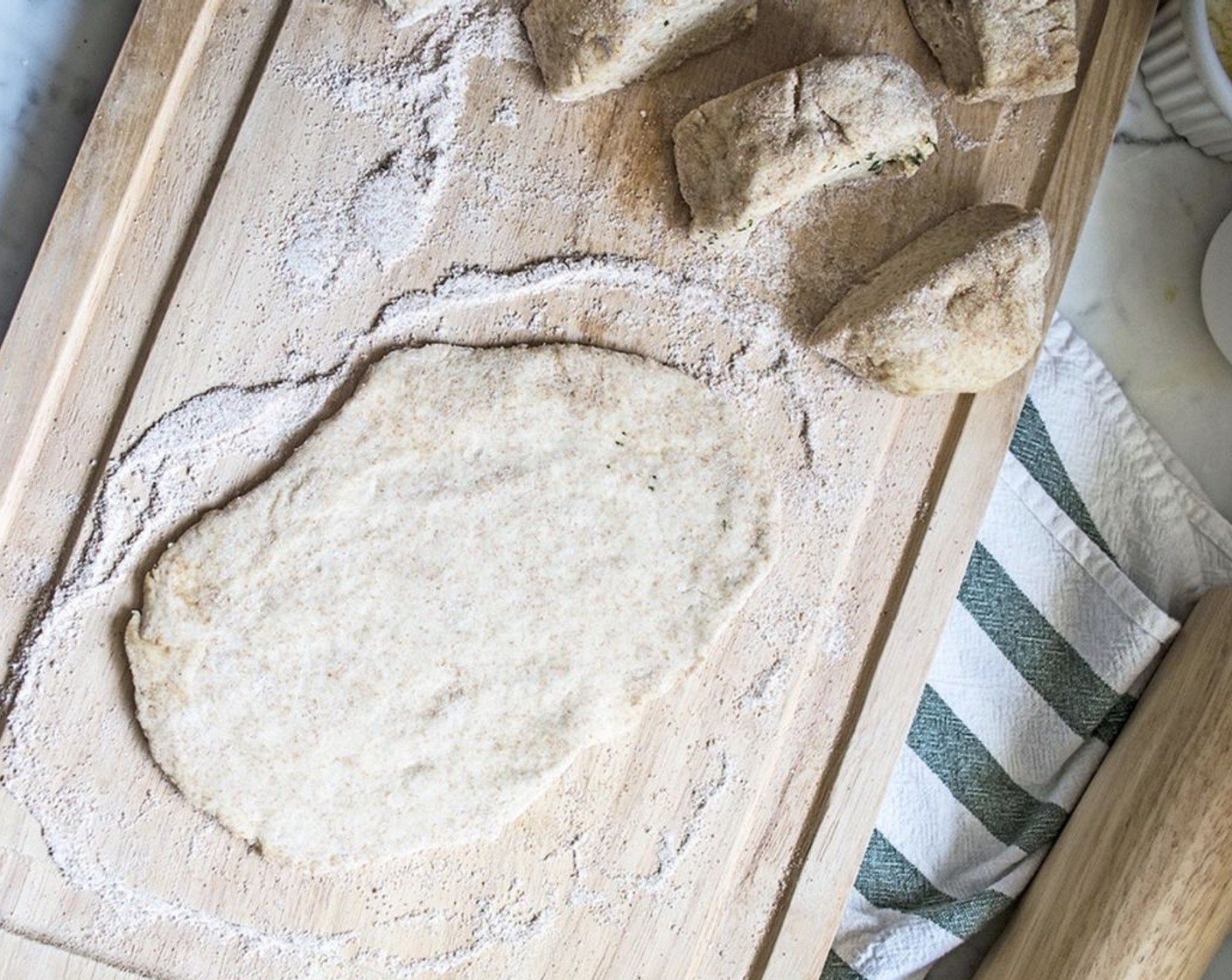 step 7 Roll each into a flat oval shape, approximately 1/4-inch thick. Allow baking sheet to get hot in the oven while you roll out the flatbread.