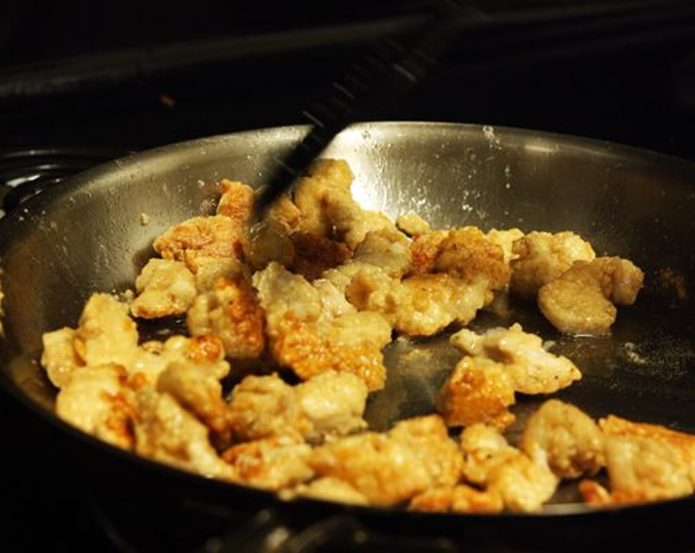 step 6 Heat Vegetable Oil (1/4 cup) in a large skillet over medium heat. Once hot, add the chicken pieces to the pan. Toss the chicken as it cooks, making sure that all sides of the pieces are crispy. Cook for 10-15 minutes until golden and crispy.