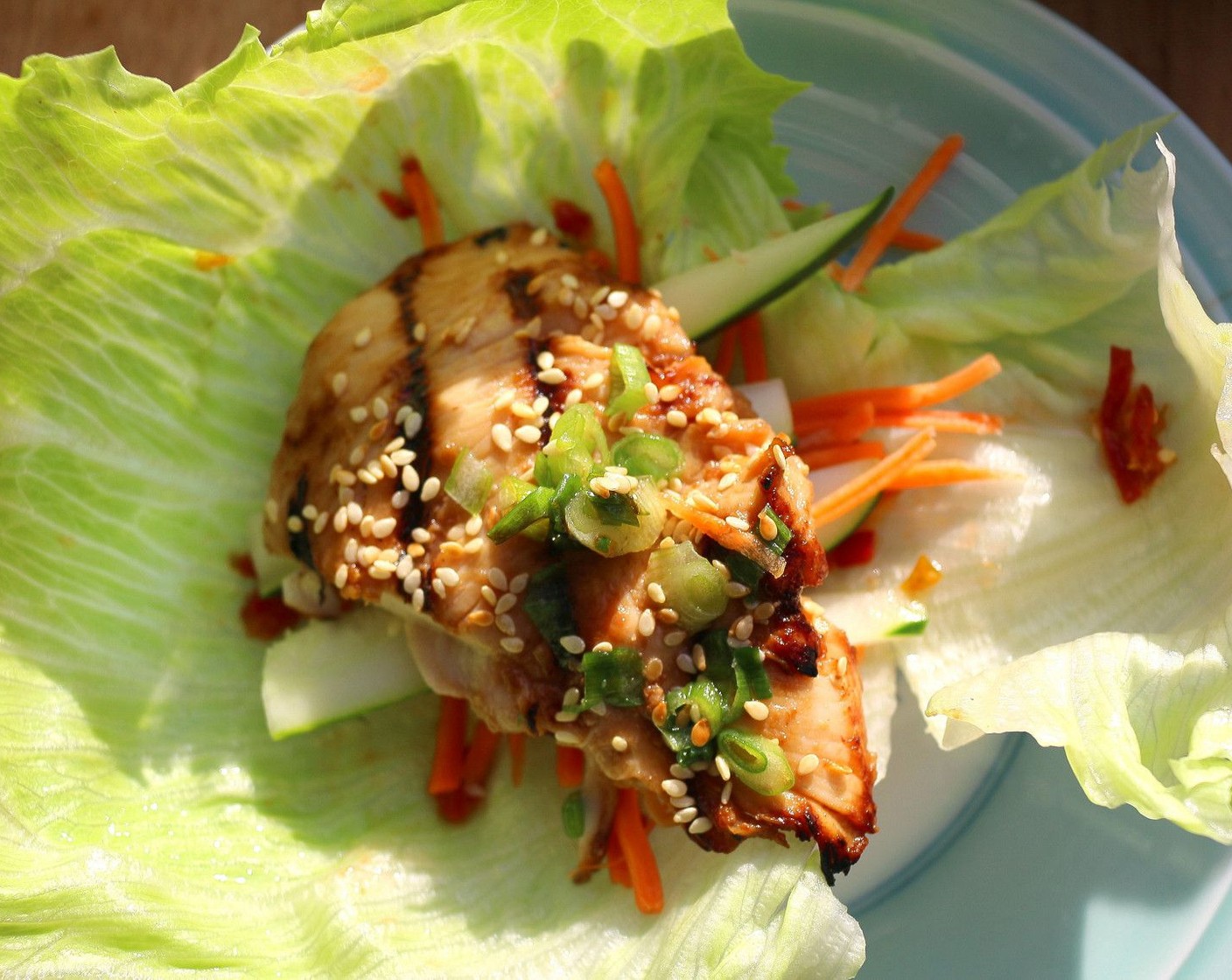 step 7 When cooked, place in a serving dish, sprinkle with more sesame seeds and sliced scallions, serve with crisp Lettuce (to taste), Fresh Basil (to taste) and Fresh Cilantro (to taste), Carrots (to taste), Cucumbers (to taste), and Ssamjang Sauce (to taste), assemble all ingredients as shown. Serve and enjoy!