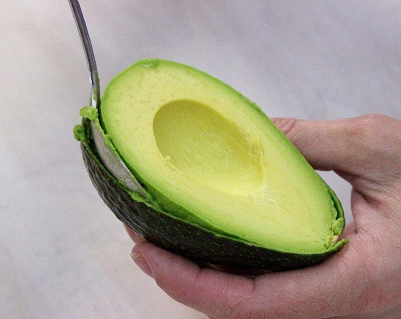 step 7 Slice the Avocados (2) in half. Use a spoon to take out the core, then scoop out the flesh of the avocado.