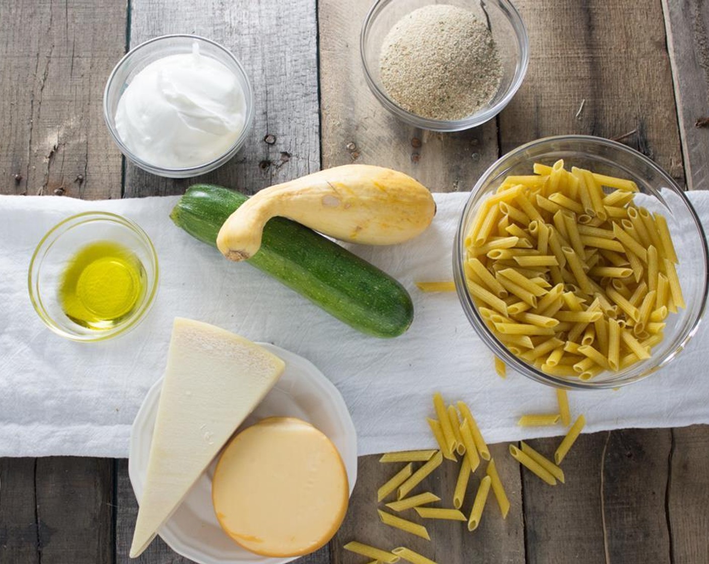 step 2 While pasta is cooking, slice and quarter the Zucchini (1) and Squash (1). Place sliced vegetables in a bowl. Grate the Parmesan Cheese (3/4 cup) and Gouda (3/4 cup).