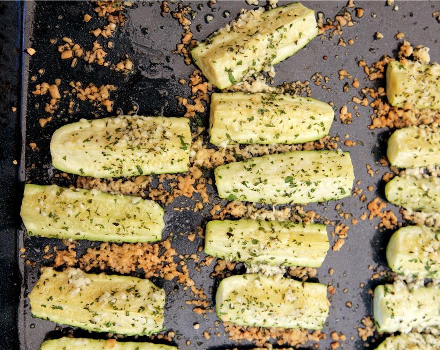 step 10 Pull the zucchini out of the oven. Slice the Tomato (1) and tear the Lettuce Leaves (4) to fit the burgers.