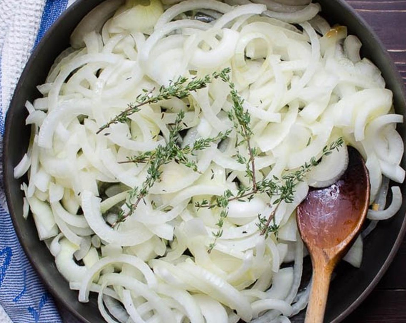 step 2 In a large skillet, heat the Olive Oil (1/4 cup) over medium-low heat. Add the onions and Fresh Thyme (4 sprigs) stir to coat with the olive oil and place a tight fitting lid on the pan. Cook for 3-5 minute. Do not brown the onions. Remove the thyme sprigs and discard.