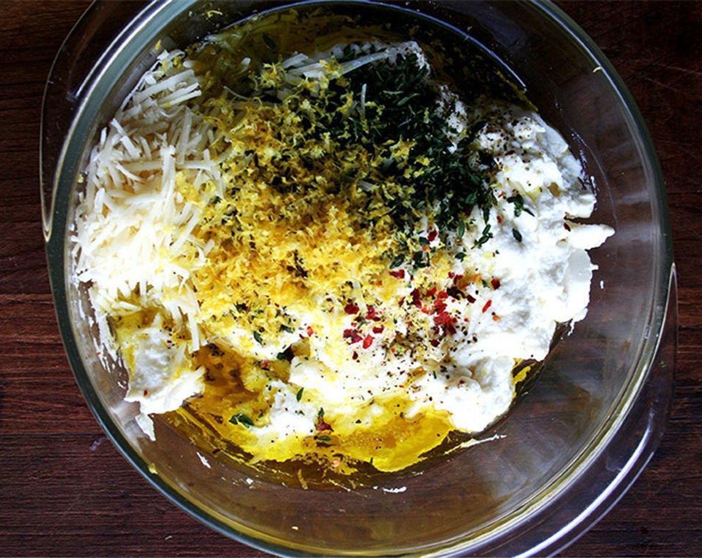 step 2 Combine Ricotta Cheese (2 cups), Garlic (3 cloves), Fresh Thyme (3 Tbsp), Lemon (1), Freshly Ground Black Pepper (to taste), Kosher Salt (1 tsp), Extra-Virgin Olive Oil (4 Tbsp), Parmesan Cheese (4 Tbsp) and Crushed Red Pepper Flakes (to taste). Mix until well combined.