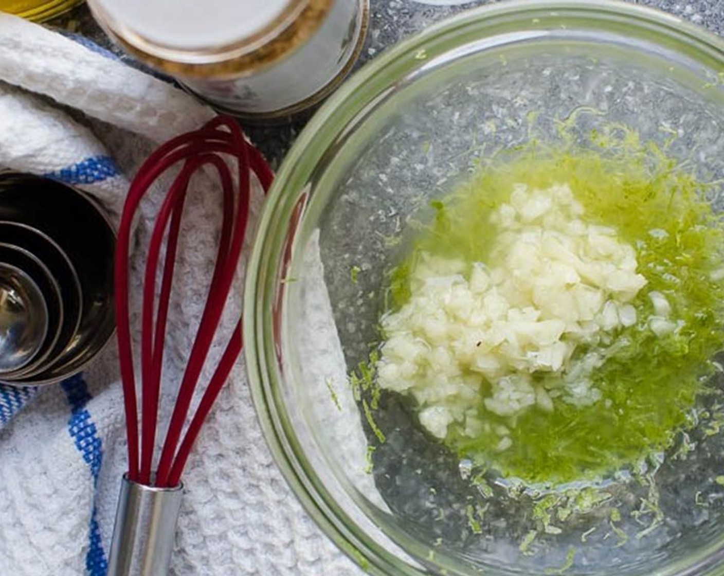 step 2 In a small bowl, combine Garlic (1 clove), zest and 2 Tbsp juice of the Lime (1), Dijon Mustard (1 tsp), Ground Cumin (1/2 Tbsp), Olive Oil (3 Tbsp), Kosher Salt (1/2 tsp)and Ground Black Pepper (1/2 tsp). Whisk until emulsified (combined).