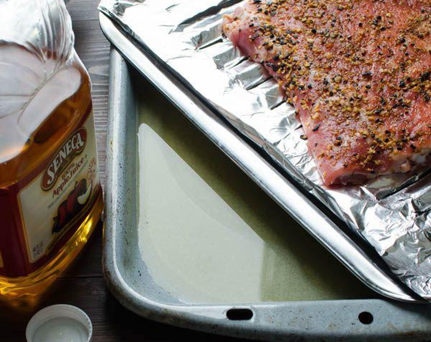 step 6 Fill the bottom portion of the broiler pan with Apple Juice (3 cups). The apple juice flavors and keeps the pork moist.