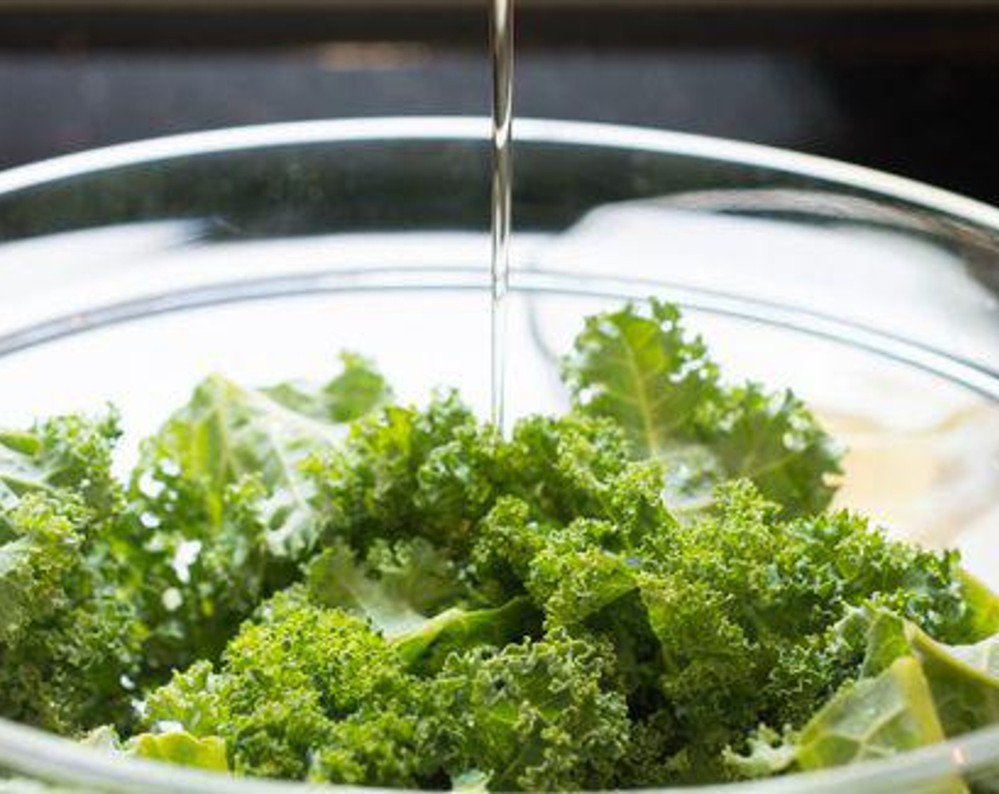 step 4 Drizzle the two tablespoons of garlic oil over the Kale (6 cups), then use your fingers to toss the kale leaves thoroughly to coat them in the oil.