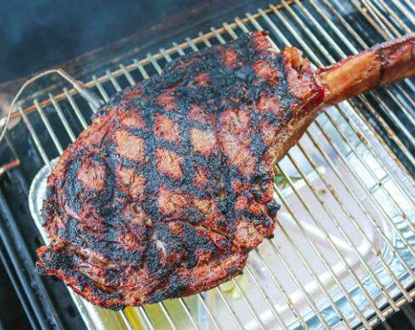 step 4 Place a shallow aluminum pan directly under the steak and add Butter (1/2 cup), Garlic (1 head), Fresh Rosemary (1 bunch), Fresh Thyme (1 bunch) and Olive Oil (1/4 cup).