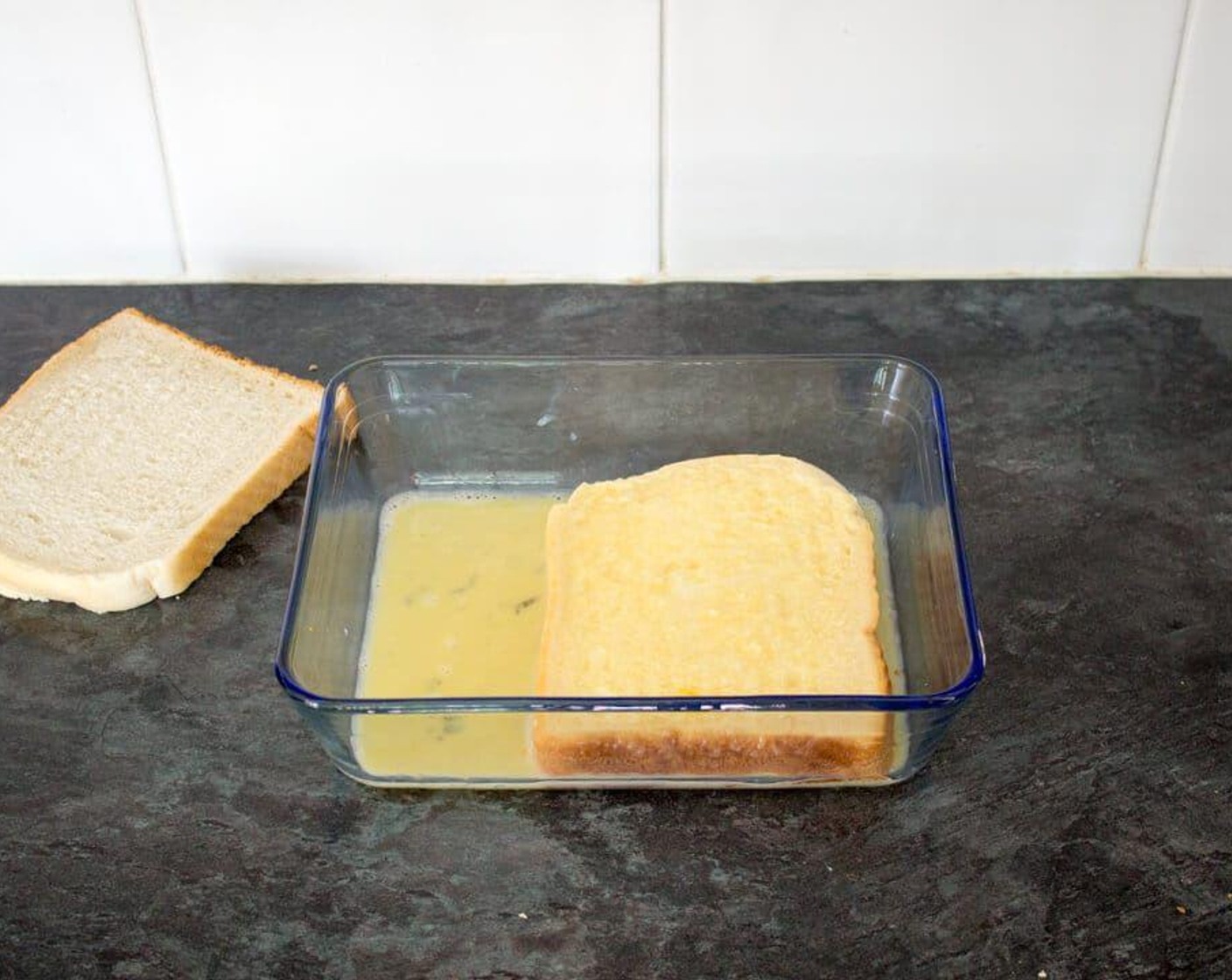 step 2 Lay both slices of White Bread (2 slices) in the egg mixture and allow to soak for a few seconds then turn them over and repeat for the other side.