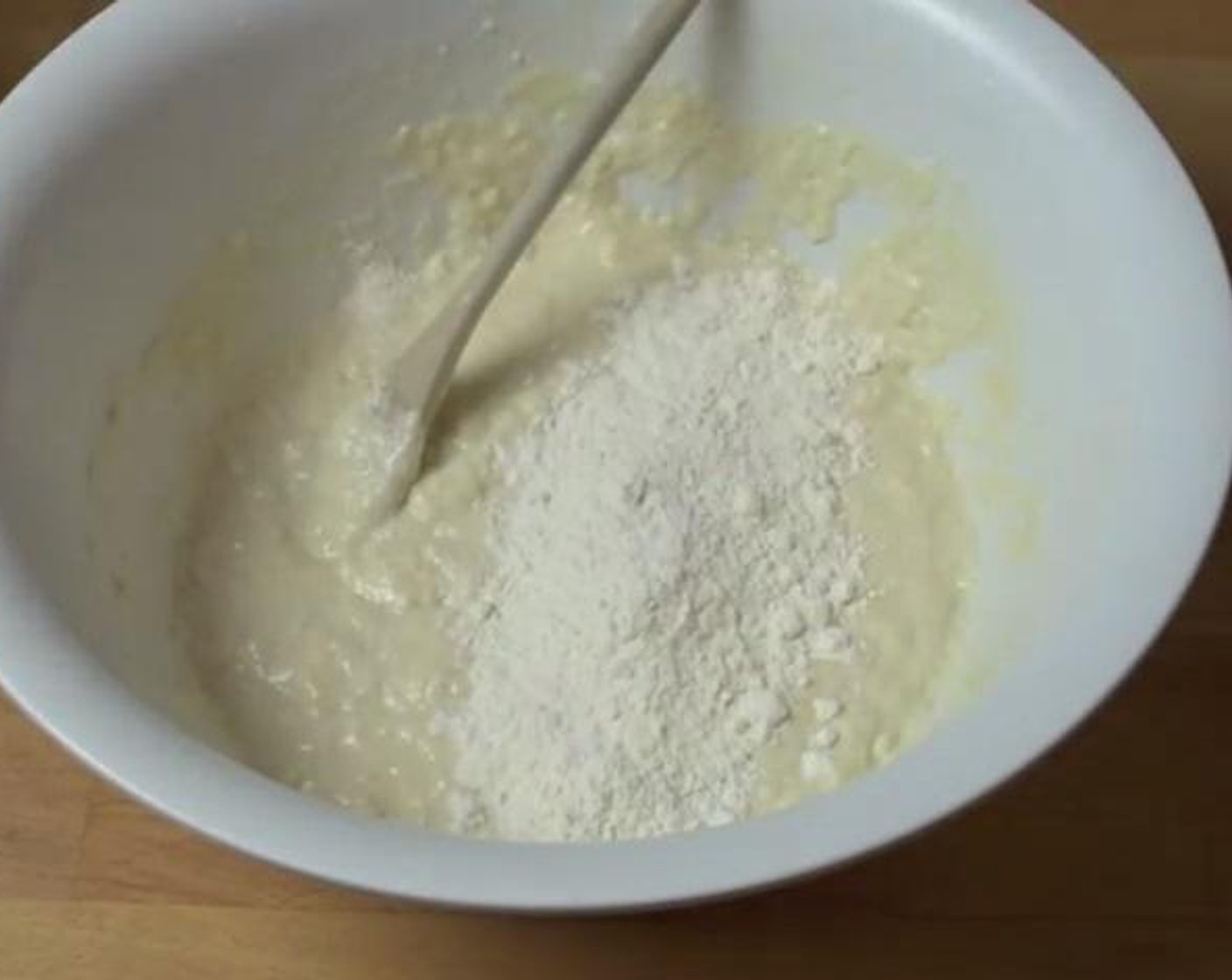 step 2 Add  the All-Purpose Flour (6 cups) to the bowl, and stir it through until a nice paste forms. Then add the remaining flour while mixing the dough.