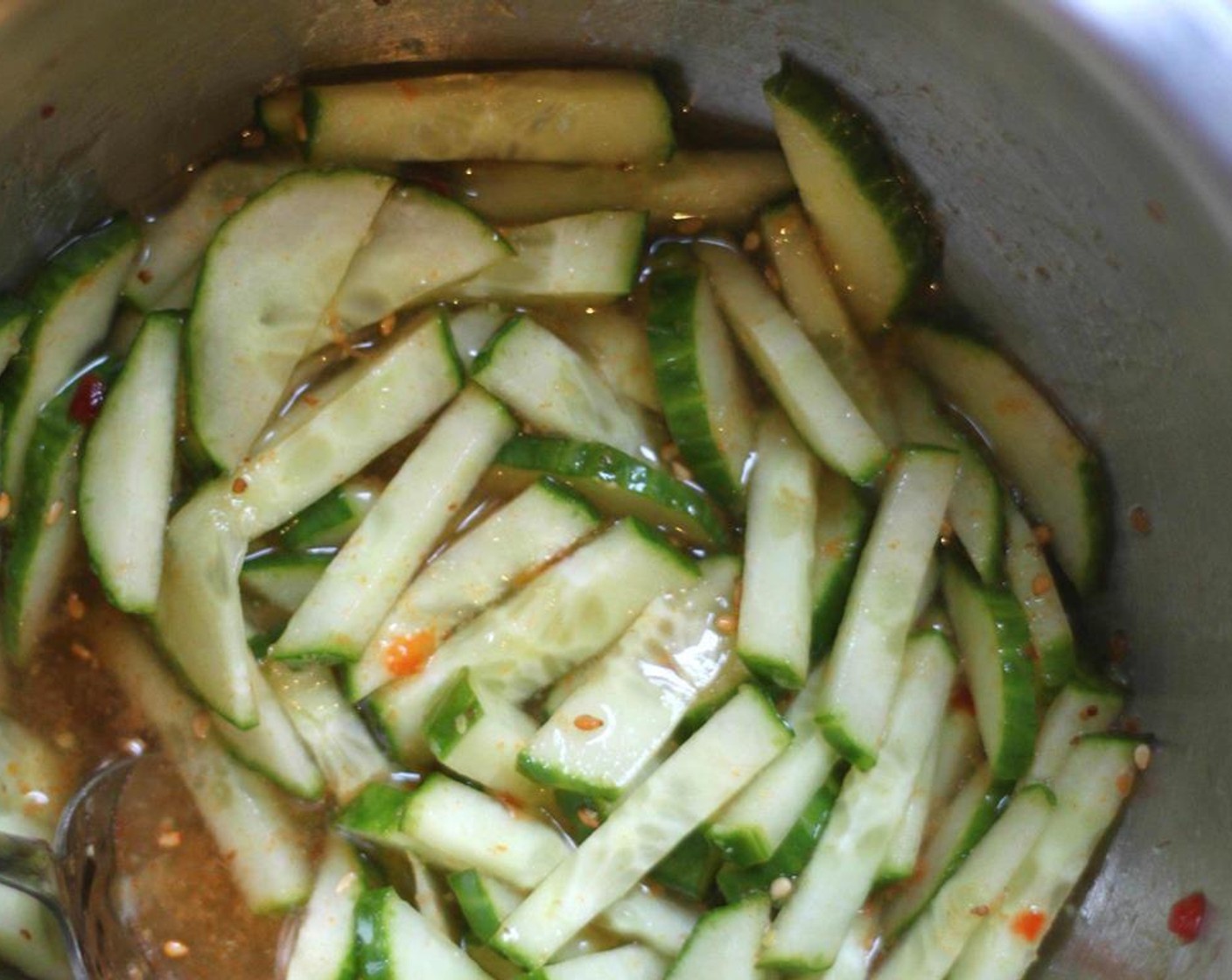 step 9 In the bowl from the marinade, add the cucumber, half of the Honey (2 Tbsp), another third of the ginger, juice of half of the Lime (1) and the remaining rice vinegar. Stir and allow to quickly pickle.