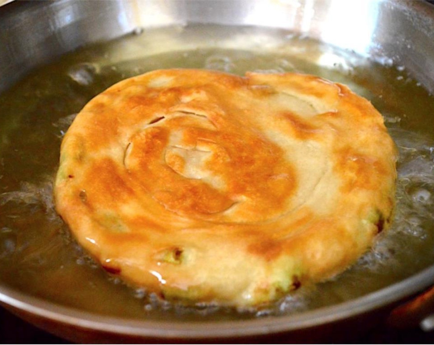 step 8 Once the oil is hot, pan fry the scallion bread for 3-4 minutes on each side to get it golden brown and crispy on the outside. It will puff up and the interior needs to cook too.