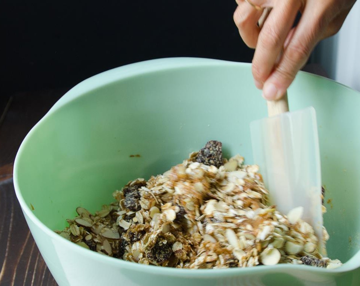 step 5 Spray your fingers with a bit of vegetable spray and rub your hands together, to prevent sticking. Turn the granola onto your prepared pan and use your fingertips to press the mixture evenly into the pan.