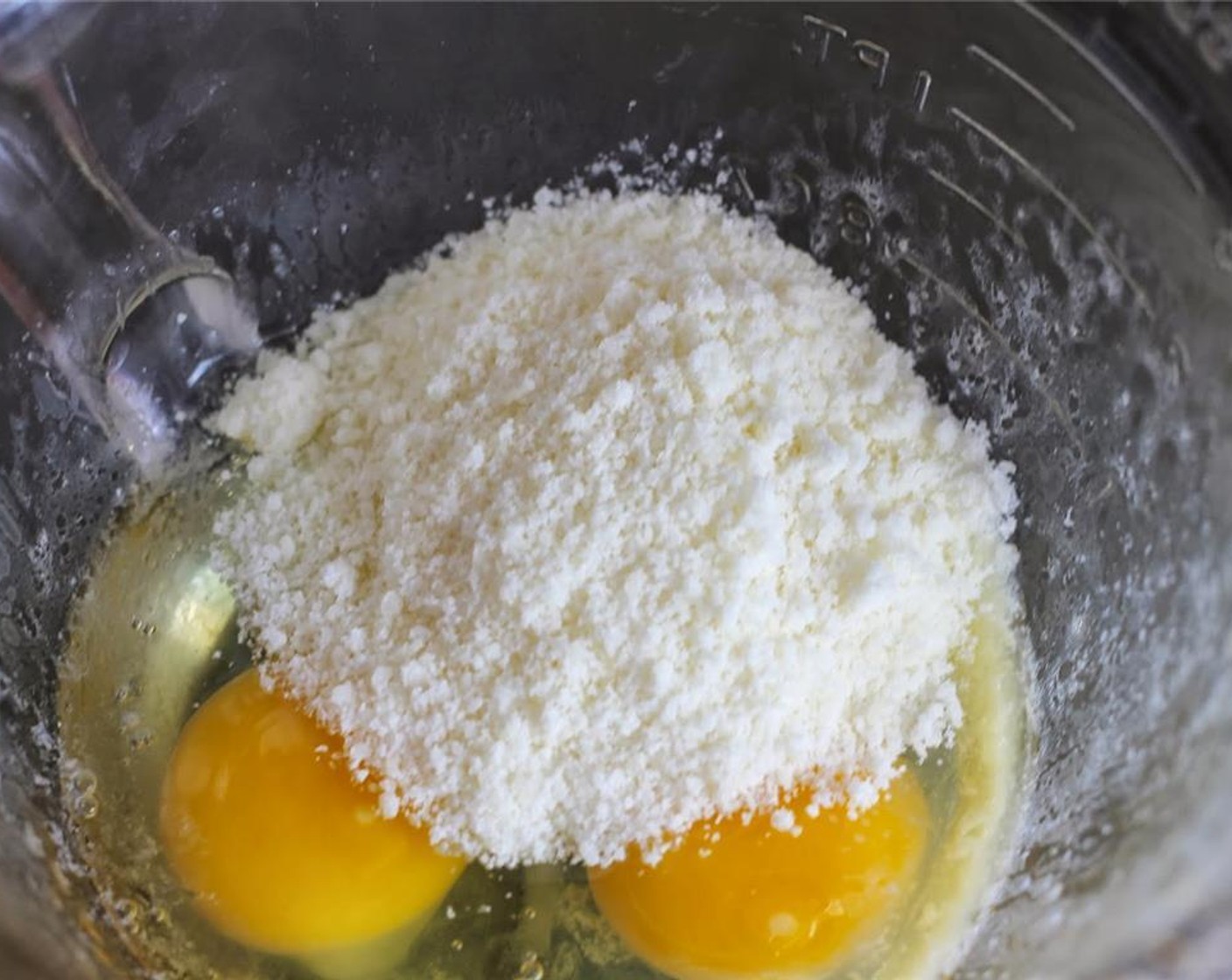 step 3 In a separate bowl, whisk Farmhouse Eggs® Large Brown Eggs (2). Add Grated Parmesan Cheese (1/2 cup) and mix well.