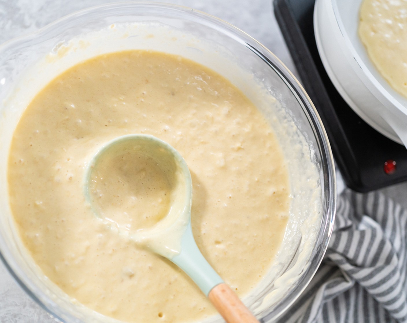 step 6 Pour the pancake batter onto the griddle. Use 1 cup-sized ladle or measuring cup for large cakes, and 1/4 cup for small. Cook for 2-3 minutes on one side until the top of the pancakes has bubbles.