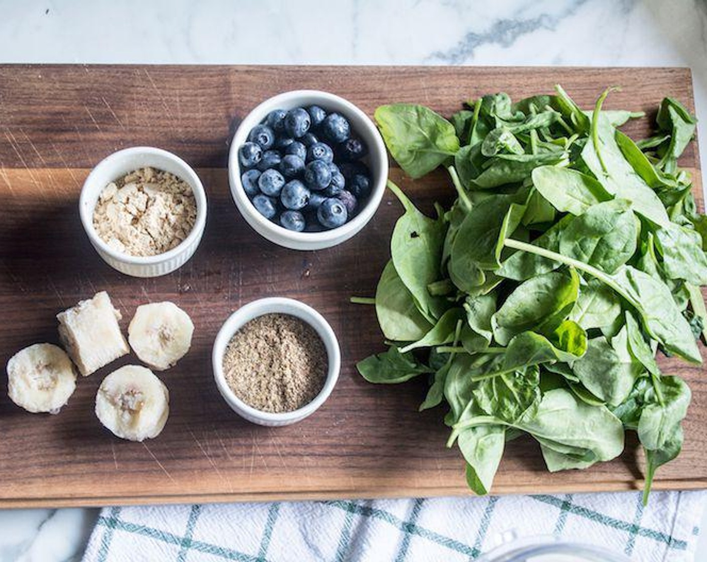 step 1 Add Unsweetened Vanilla Almond Milk (1 cup), Ice (to taste), Banana (1/2), Frozen Blueberries (1/2 cup), Ground Flaxseed (2 Tbsp), Powdered Peanut Butter (2 Tbsp), Stevia (3 pckg), and Fresh Spinach (2 cups) to blender or Ninja smoothie attachment, blend on high for 40-60 seconds.