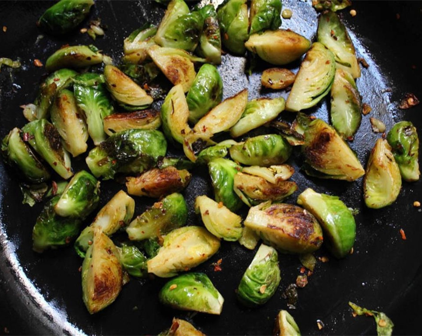 step 2 Add the Crushed Red Pepper Flakes (1/2 tsp) and Salt (1 pinch) to the sprouts and cook, stirring periodically, for about 15 minutes until lightly browned and tender. Set aside while you cook the farro.