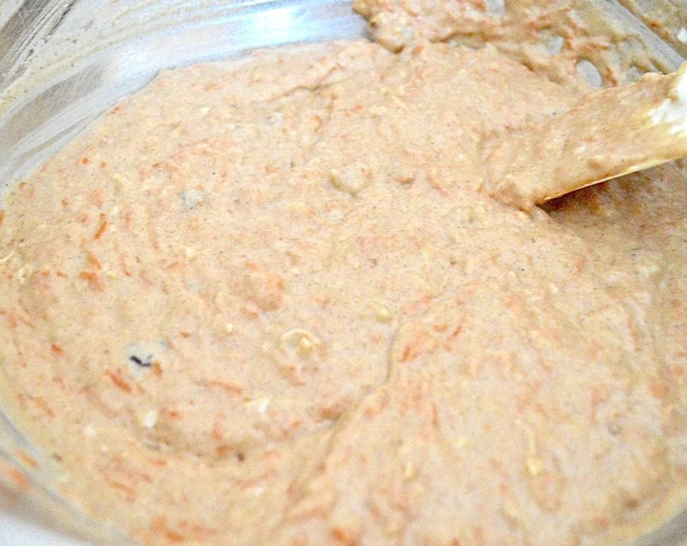 step 3 Pour those wet ingredients into the dry ingredients and whisk them together until it becomes a thick, smooth batter. Switch to a spatula and fold in the Carrots (4), Walnuts (4 Tbsp), Sun-Maid Raisins (4 Tbsp), and Unsweetened Shredded Coconut (4 Tbsp).