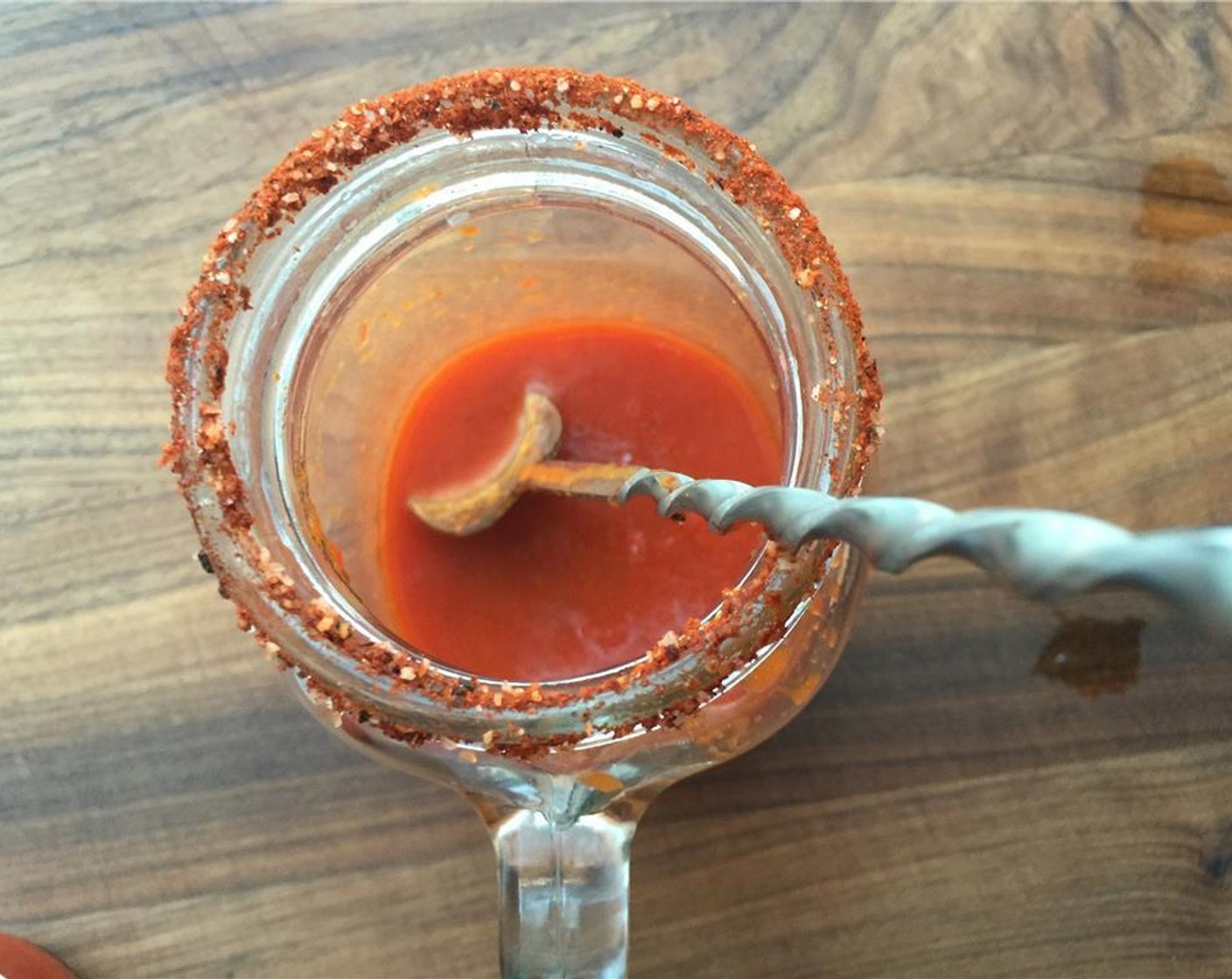 step 3 To the glass, add Tomato Sauce (2 Tbsp), Maggi Seasoning (1/2 tsp), Worcestershire Sauce (1 tsp), Hot Sauce (1 tsp) and the juice from Lime (1). Combine with a bar spoon.