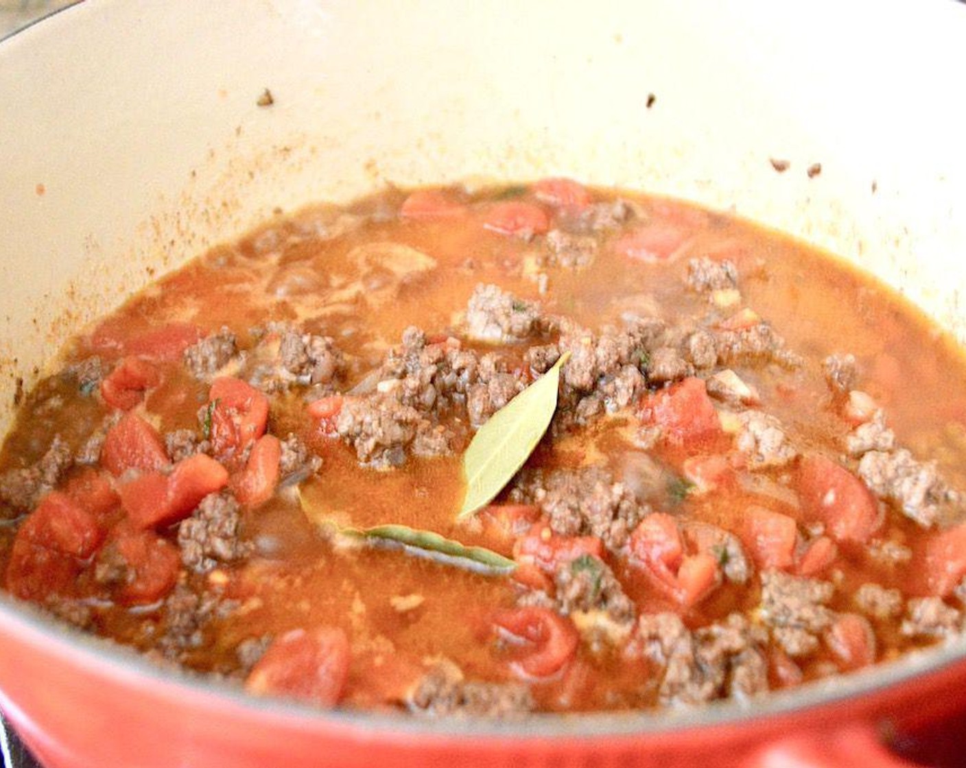 step 4 Finally, add in the Diced Tomatoes (1 can) and Bay Leaves (2). Bring it to a boil, then reduce it to a simmer to cook for 45 minutes.
