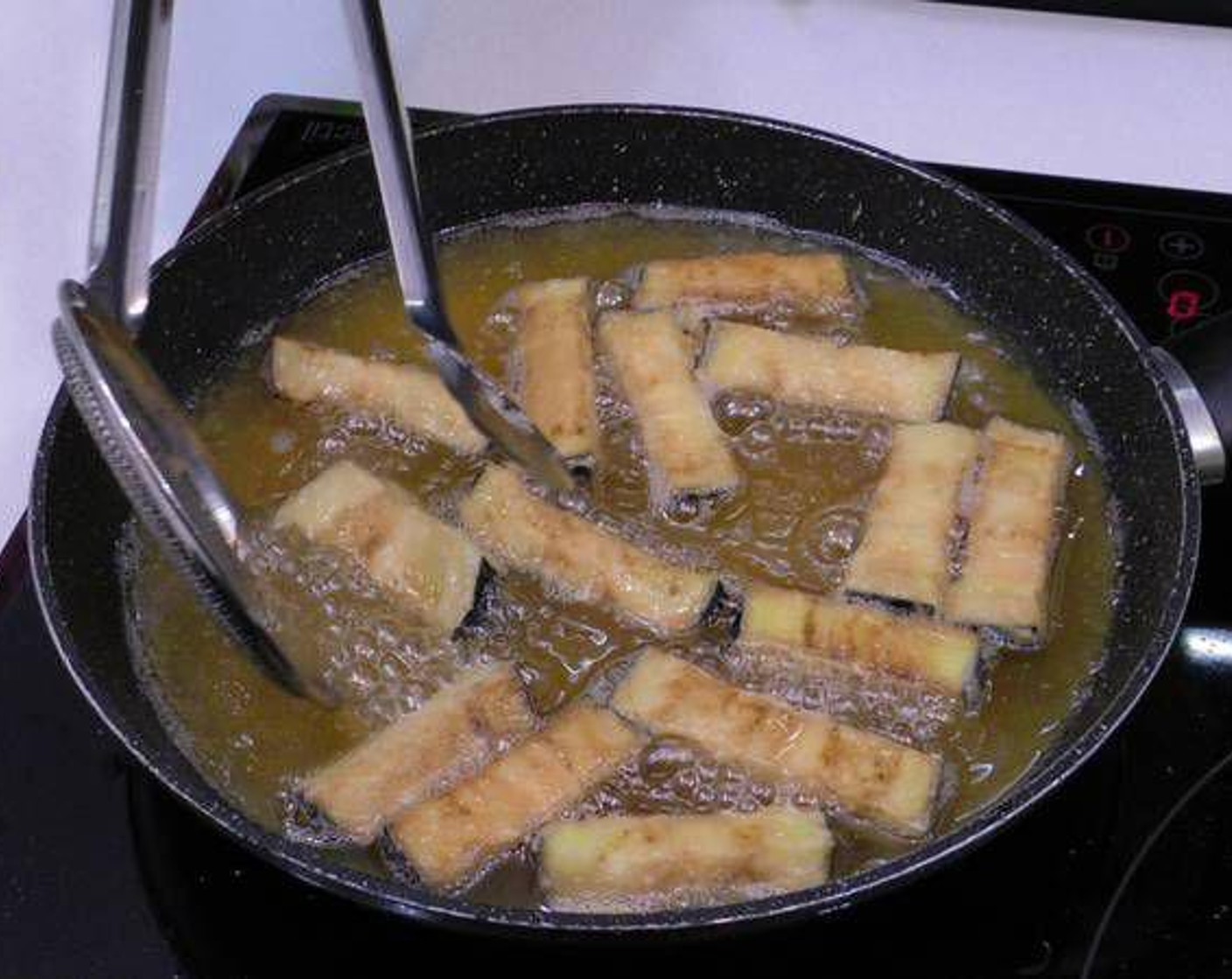 step 3 In a large pan add Frying Oil (as needed) and set to high heat. Once hot, add the eggplant sticks.