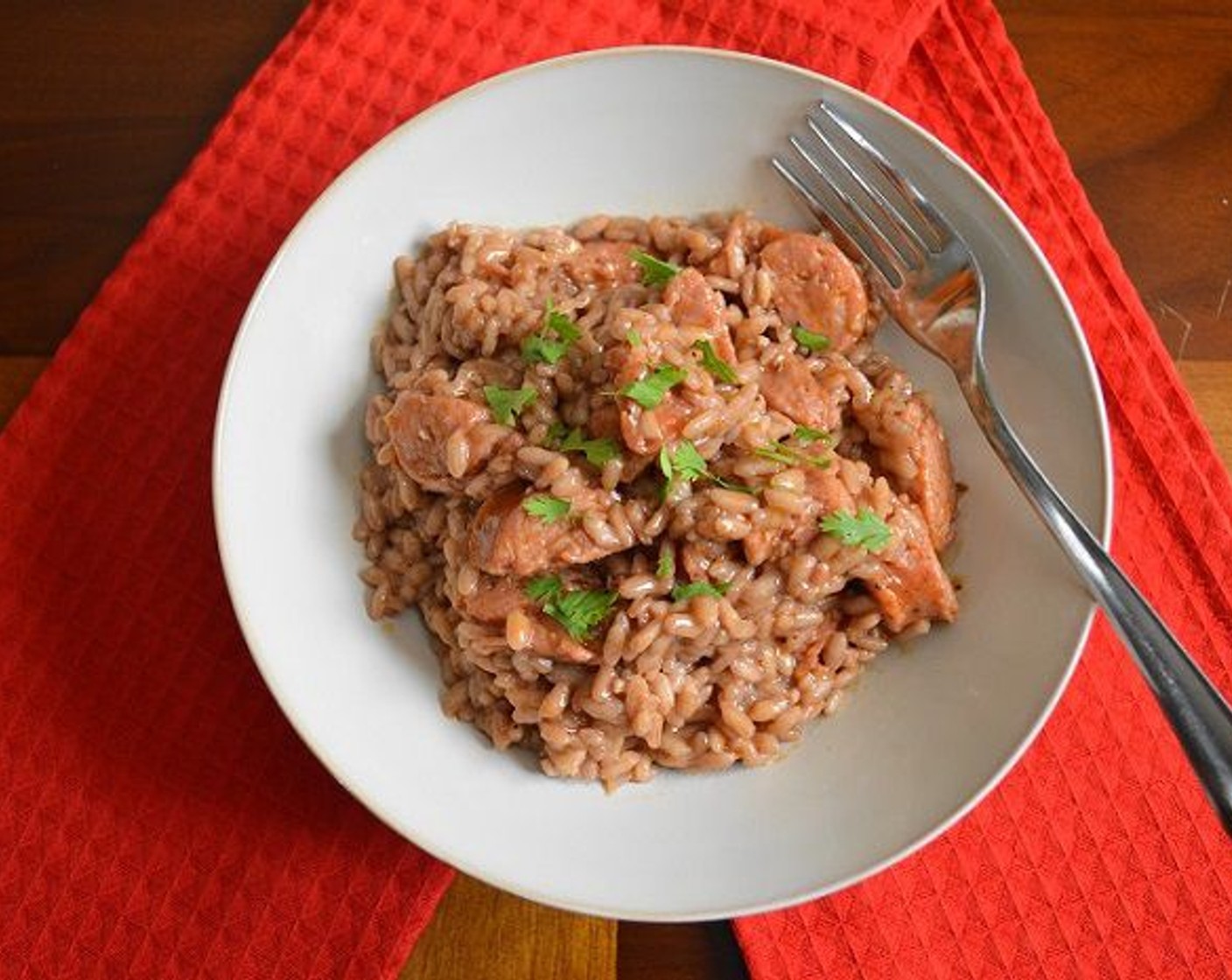 step 6 Stir the andouille and the Manchego Cheese (1 cup) into the risotto, then take the pan off of the heat. Scoop it into pretty bowls and top it with a sprinkle of Fresh Cilantro (to taste). Serve immediately and enjoy!