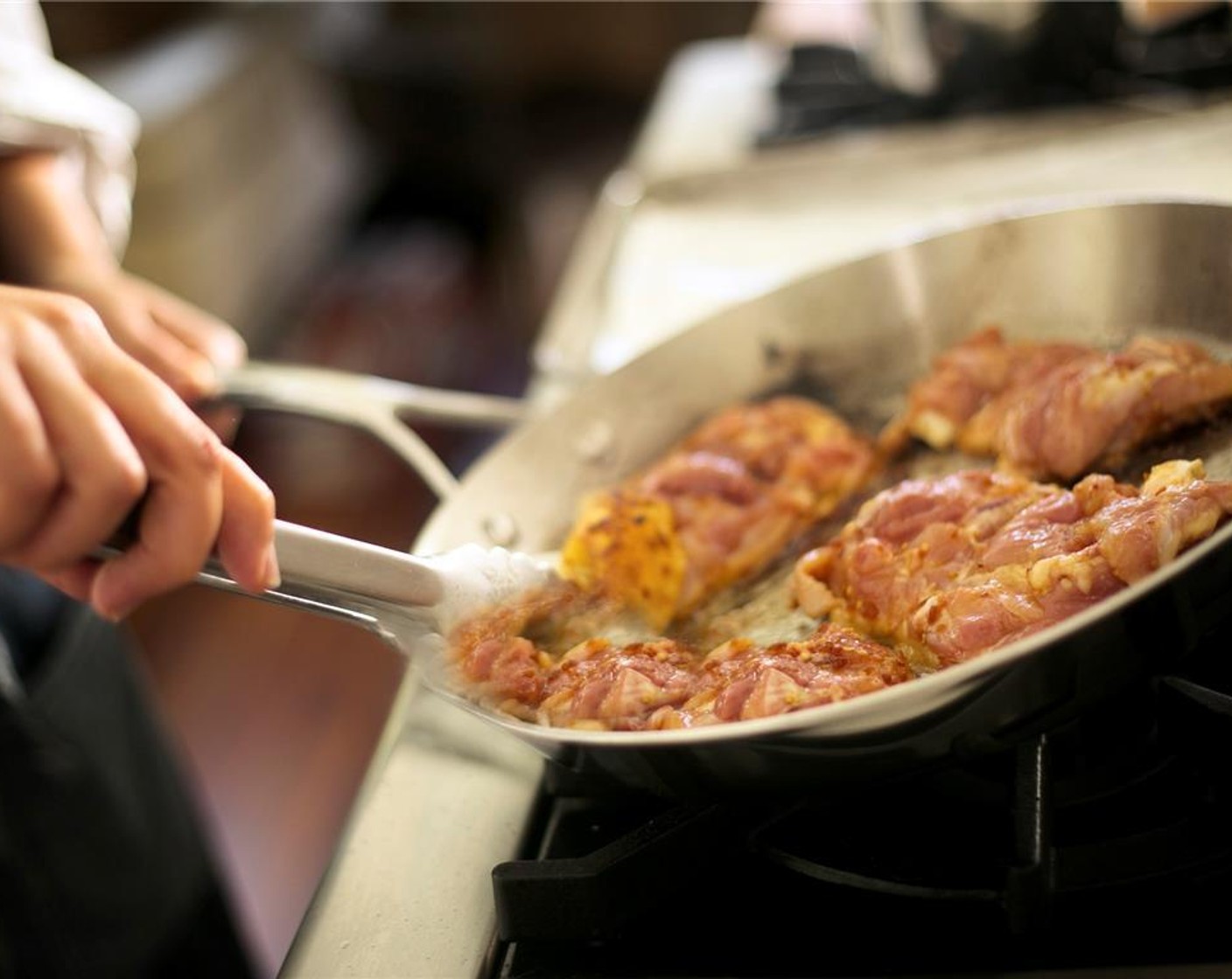 step 7 Once pan is hot, add chicken thighs skin side down. Cook for three minutes until the skin starts to brown.