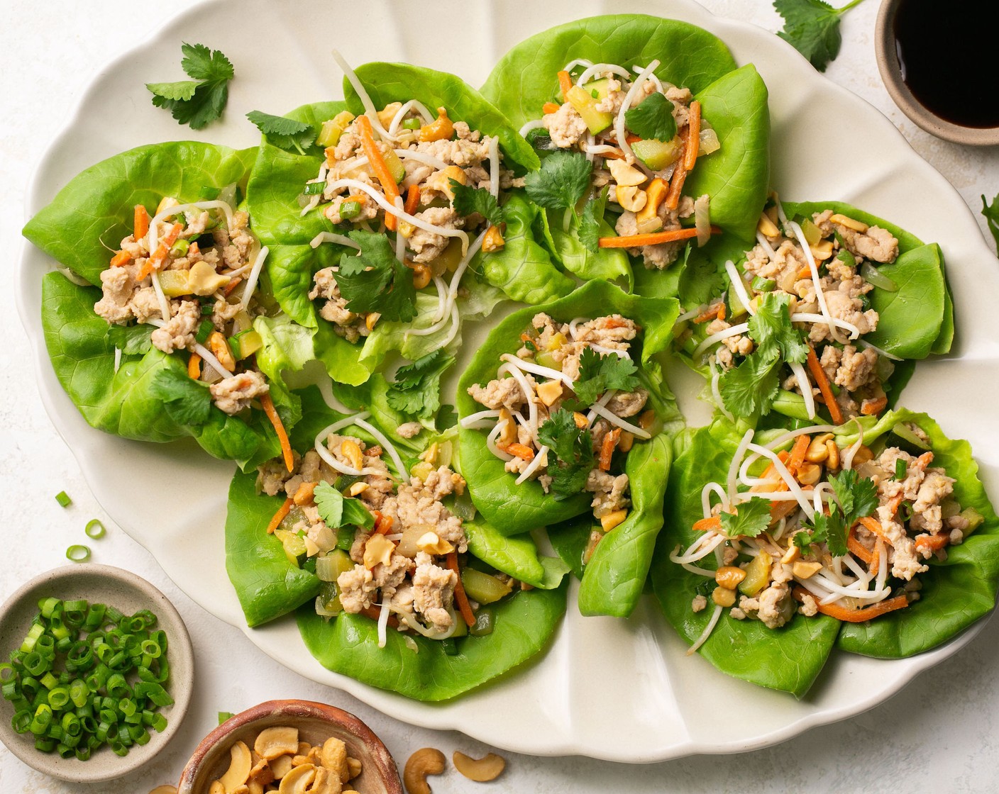 step 5 Right before serving, stir in Bean Sprouts (3/4 cup), Scallion (1 bunch), Toasted Cashew Nuts (1/2 cup), and Fresh Cilantro (to taste). Scoop into Butter Lettuce (to taste) and serve.