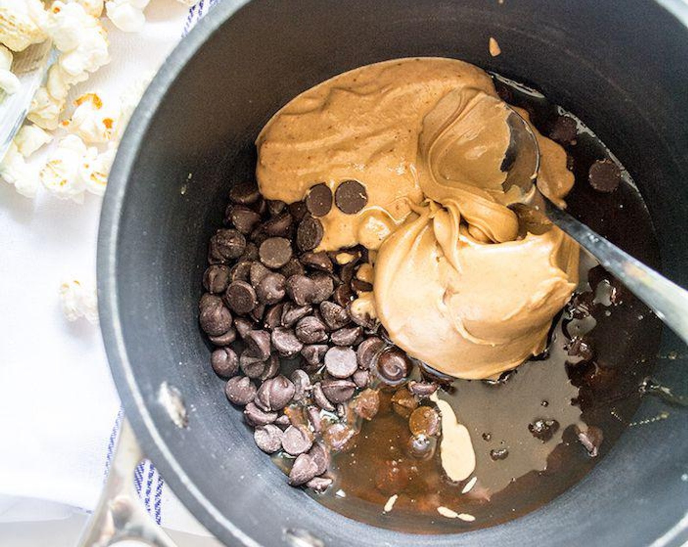 step 1 Mix Powdered Peanut Butter (1/4 cup) with Water (3 Tbsp), then add to small sauce pan with Semi-Sweet Chocolate Chips (1/2 cup), Creamy Peanut Butter (1/4 cup) and Raw Honey (1/3 cup). Cook over medium-low heat, stirring continuously, until all chocolate chips have melted and ingredients are well combined.