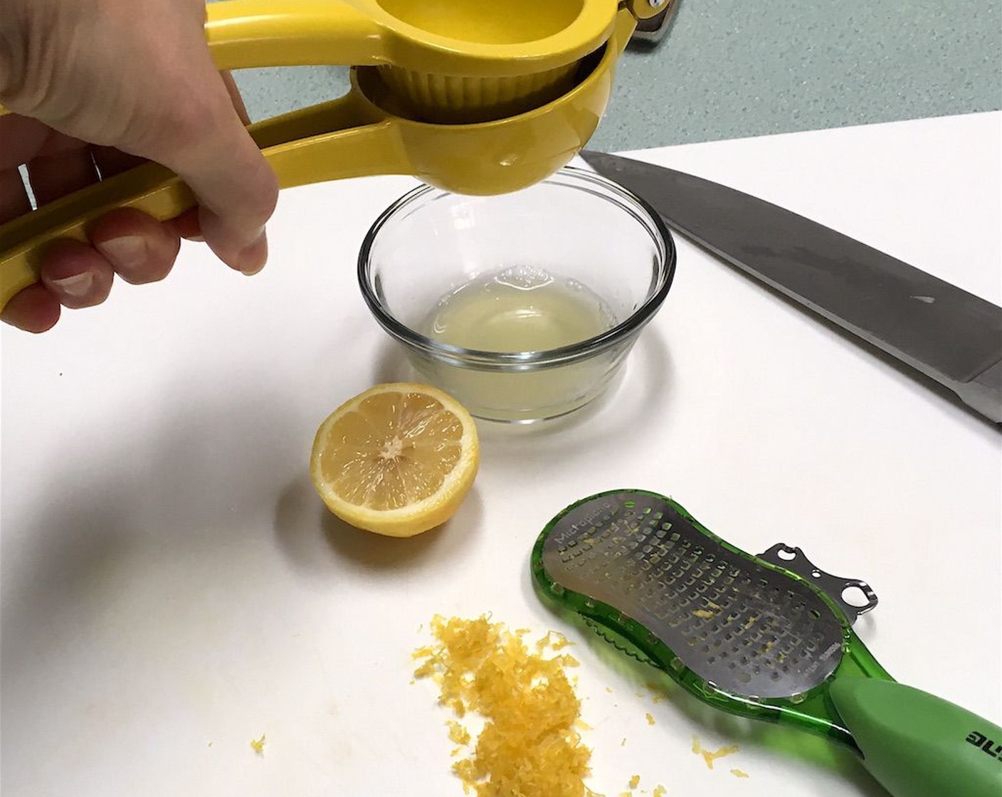 step 10 Once zested, squeeze juice from the lemon.